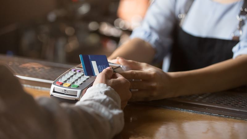 Man using credit card at card reader