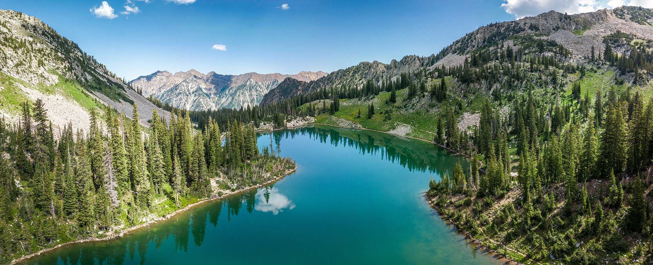 clear blue lake in the middle of a mountain range